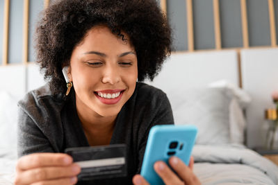 Portrait of young woman using mobile phone