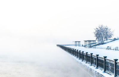 Scenic view of snow covered land against sky