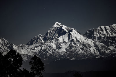 Scenic view of snowcapped mountains against clear sky