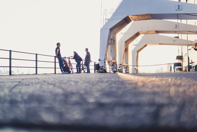 People walking on road against buildings