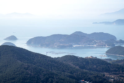 High angle view of sea and mountains against sky