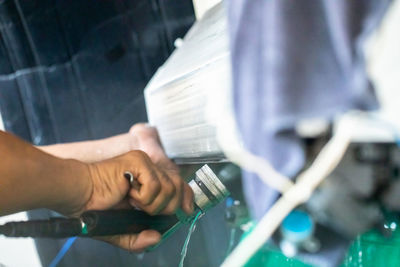 Cropped hand of man repairing car
