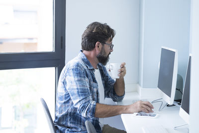 Side view of man working at office