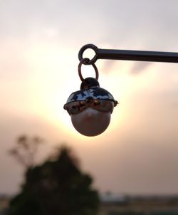 Close-up of silhouette chain against sky during sunset