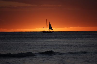 Sailboat in sea at sunset