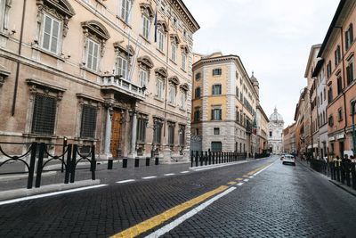 Road amidst buildings in city