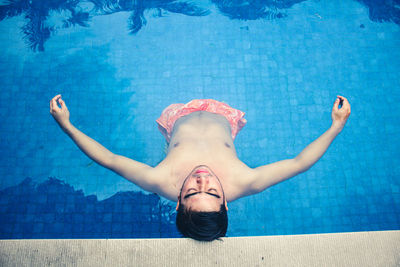 High angle view of man relaxing in swimming pool