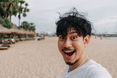 Portrait of smiling young man on beach