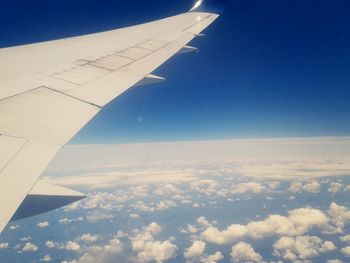 Cropped image of airplane wing over landscape