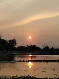 Scenic view of lake against sky during sunset