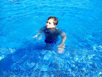 High angle view of boy swimming in pool