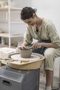 Female potter holding pottery