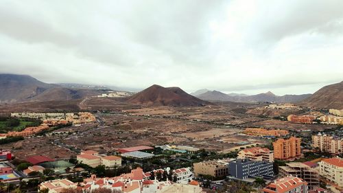 Cityscape against cloudy sky