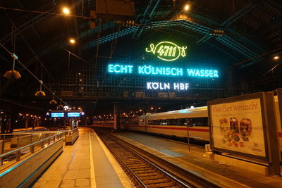 Illuminated railroad station platform at night