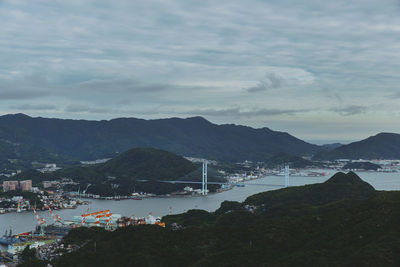 High angle view of townscape by sea against sky