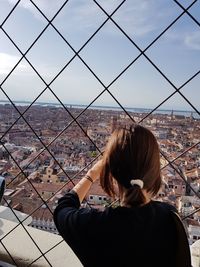 Rear view of woman with cityscape in background