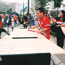 Side view of a man using mobile phone on table