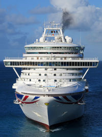 Ship moored at harbor against sky