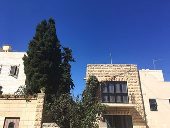 Low angle view of house against clear blue sky