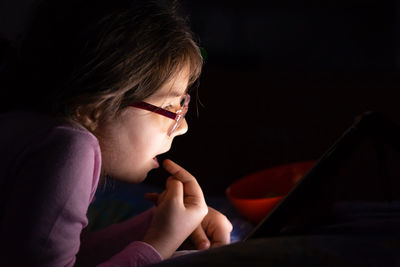 Close-up of girl using technology at home