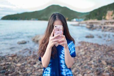 Portrait of woman standing on beach