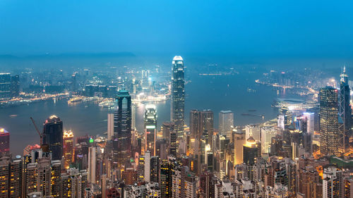 High angle view of illuminated cityscape against sky at night