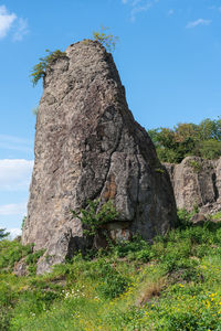 Low angle view of rock formation on land against sky