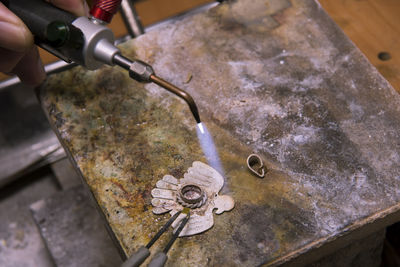 High angle view of human hand on metal