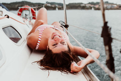 Portrait of woman relaxing in boat on sea