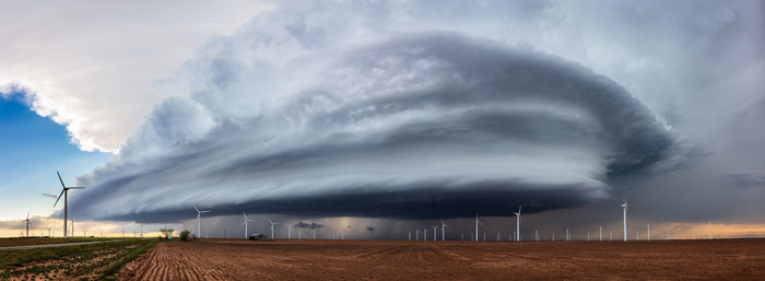 Panoramic view of a dramatic supercell thunderstorm over a wind farm near hermleigh, texas.