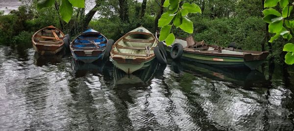 Boats moored in river