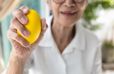 Close-up of hand holding red fruit