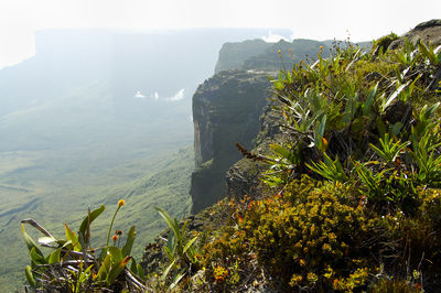 Scenic view of sea and mountains against sky