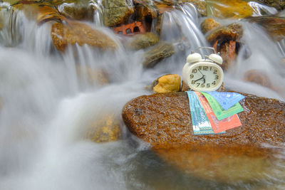 Waterfall along rocks in sea