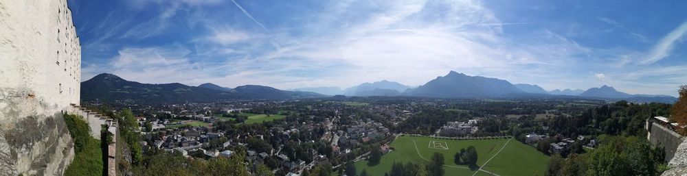 Panoramic view of buildings and mountains against sky