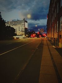 Road by city against sky