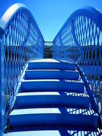 Low angle view of staircase against blue sky
