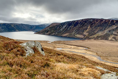 Scenic view of lake and mountains against sky