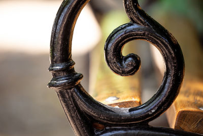 Close-up of wrought iron on bench