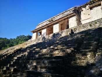 Low angle view of historical building against blue sky