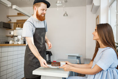 Side view of man working at table