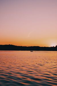 Scenic view of lake against romantic sky at sunset