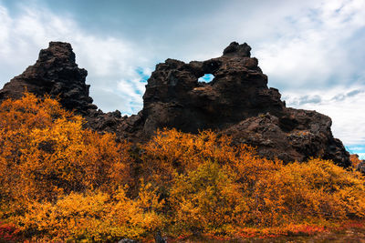 Low angle view of rock formation against sky