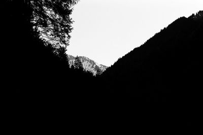Low angle view of silhouette mountain against clear sky