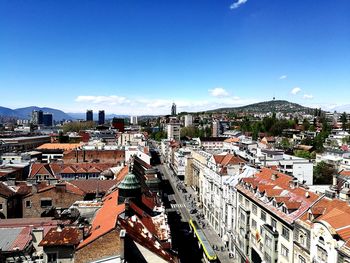High angle view of town against blue sky