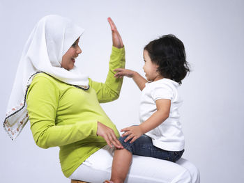 Side view of a mother and daughter