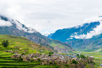 Scenic view of mountains against cloudy sky