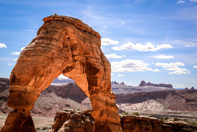 View of rock formation against cloudy sky