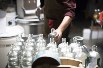 Bottles of liquor being filled at a distillery.