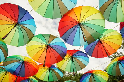 Low angle view of multi colored umbrella against sky